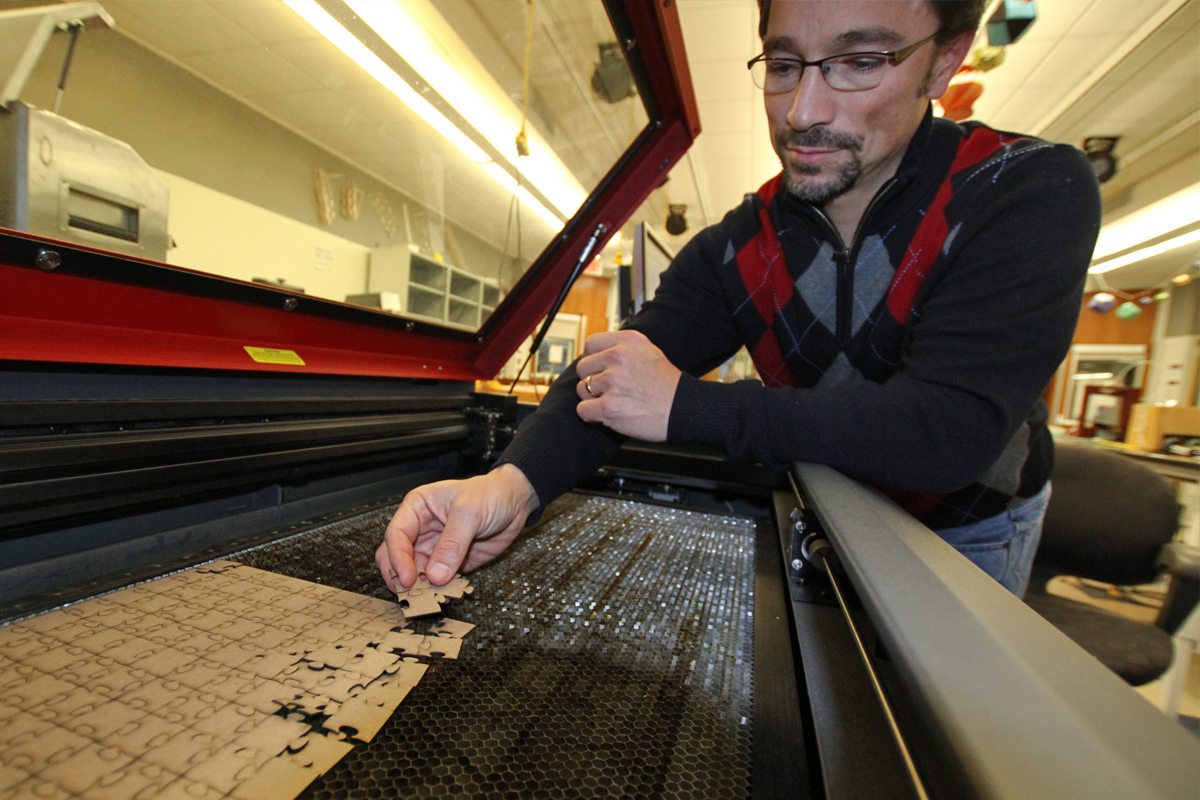 Science Instructor David Gulick with a new laser cutter in Exeter's maker space.