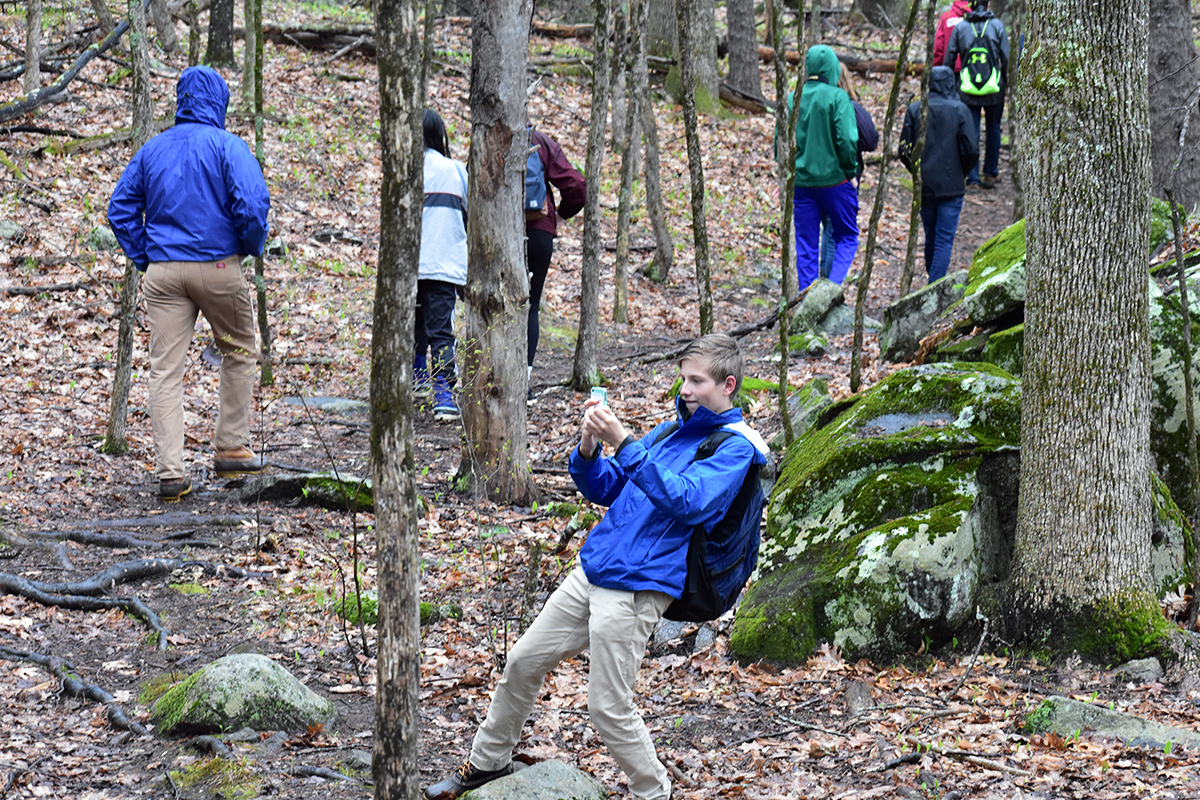 A student snaps a photo during a hike through the Lubberland Creek Preserve in Newmarket. 