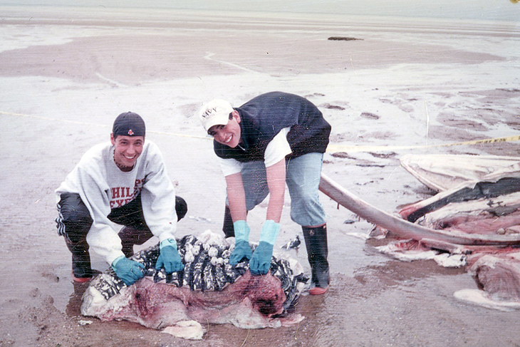 Freddy Kullman and Reed Macy remove flesh and fat from the whale carcass