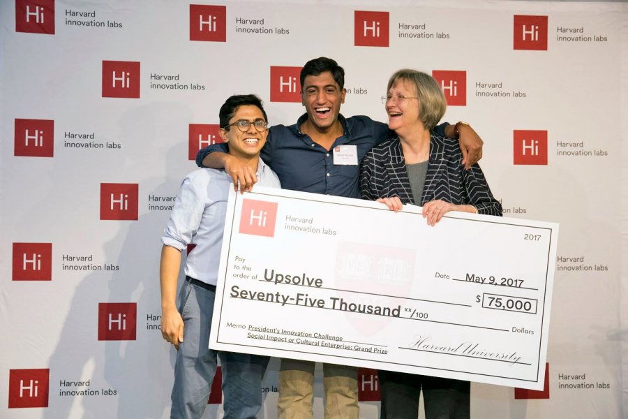 Milton Syed '14 and Rohan Pavuluri '14 accept a prize grant check from Harvard President Drew Faust.