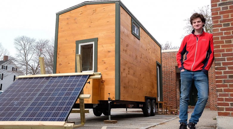 Jed Breen '19 stands beside his senior project — a tiny house he built by hand.