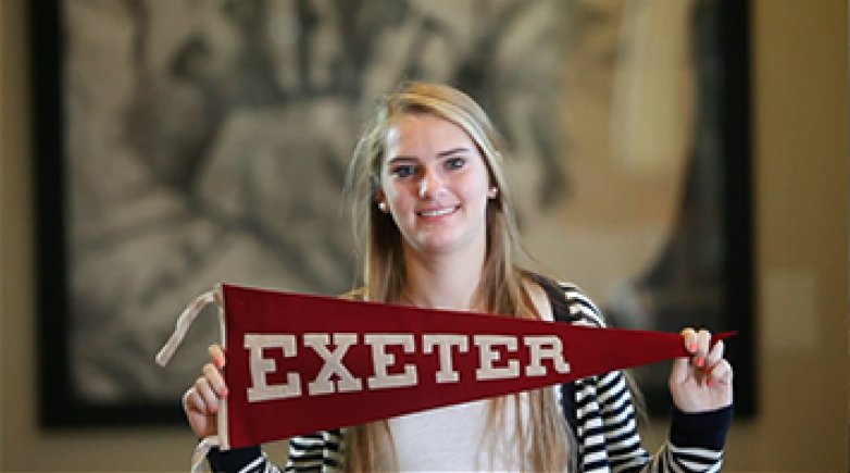 Student holding Exeter banner
